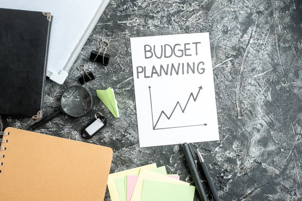 top-view-budget-planning-note-with-pens-gray-surface-job-copybook-school-student-business-work-college-money-budget